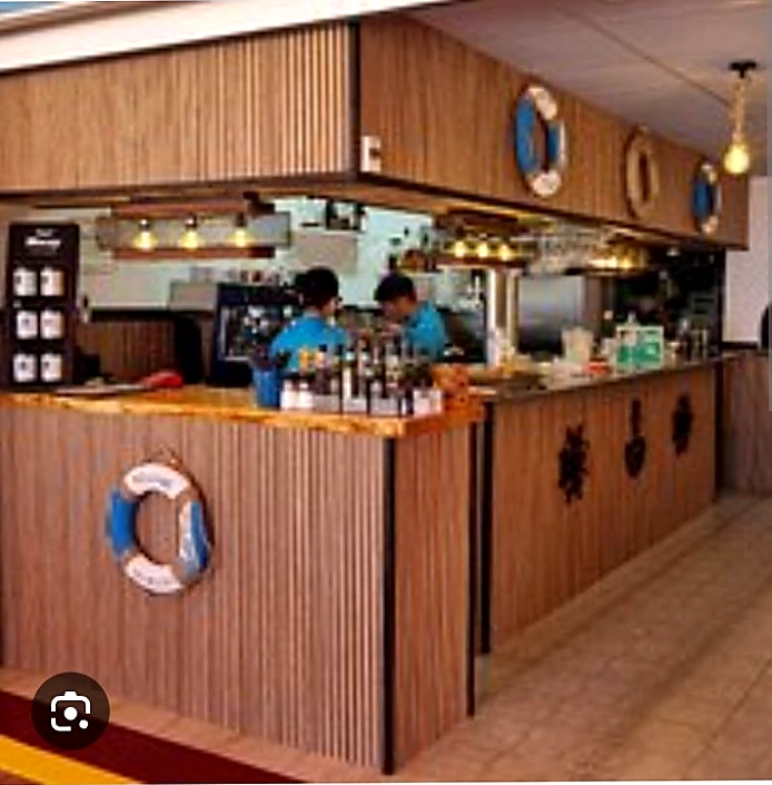 Flipper bar after renovation, with vertical timber-slat counter, slatted overhead canopy and new lighting